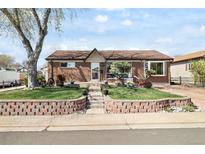 Charming brick home with a well-maintained front yard and retaining wall at 10769 Murray Dr, Northglenn, CO 80233