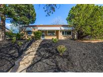 Charming single-story brick home featuring well-maintained landscaping and inviting curb appeal at 3430 N Clayton St, Denver, CO 80205