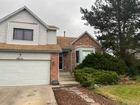 Charming two-story home featuring a brick facade and an attached two-car garage at 20391 E 42Nd Ave, Denver, CO 80249