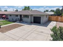 Charming single-story home with an attached garage and well-maintained landscaping at 235 N 12Th Ave, Brighton, CO 80601