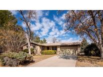 Charming single-story home with an attached garage and mature landscaping at 1501 E Panama Dr, Centennial, CO 80121