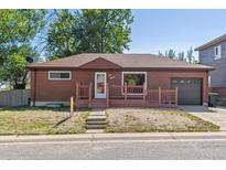 Brick ranch home with attached garage and front porch at 1104 Elmer Dr, Northglenn, CO 80233