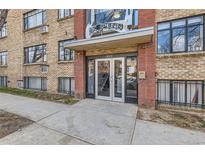 Apartment building entrance featuring brick facade and glass doors to welcome residents and guests alike at 500 E 11Th Ave # 305, Denver, CO 80203