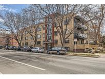 Brick apartment building boasts a central entryway and street parking at 500 E 11Th Ave # 305, Denver, CO 80203