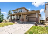 Charming home featuring a covered porch, portico, and well-maintained landscaping at 12119 S Wanderlust Way, Parker, CO 80138