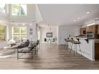 Bright open-concept living room featuring high ceilings, modern decor, and a breakfast bar at 11300 Night Heron Dr, Parker, CO 80134