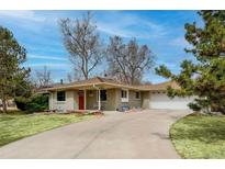 Charming single story home with a well-manicured lawn and a brick exterior at 9405 W 54Th Pl, Arvada, CO 80002