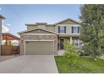 Beautiful two-story home featuring a stone accent wall, spacious garage and a cozy front porch with classic columns at 4827 S Coors Ln, Morrison, CO 80465