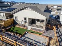 Aerial view showcasing the home's backyard, landscaping, and patio at 17412 W 93Rd Pl, Arvada, CO 80007