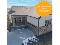 Charming single-Gathering home featuring a covered front porch and a two-car garage at 17412 W 93Rd Pl, Arvada, CO 80007