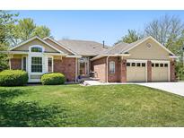 Charming home with brick accents, well-kept lawn, and attached two-car garage at 7276 Brighton Ct, Castle Pines, CO 80108