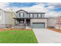 Charming two-story home with a well-manicured lawn and a two-car garage at 23998 E Atlantic Pl, Aurora, CO 80018