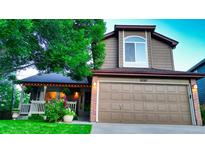 Charming two-story home featuring well-maintained front lawn, brick accents, and a spacious two-car garage at 5150 Morning Glory Pl, Highlands Ranch, CO 80130