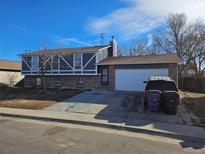 Charming two-story home with a brick and siding exterior, a two-car garage, and a driveway at 4582 Frankfort Way, Denver, CO 80239