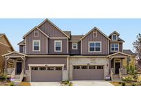 Charming townhome featuring modern architecture, two-car garage, and welcoming front porch at 6740 Juniper Dr, Thornton, CO 80602