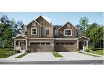 Beautiful two-story townhome with neutral siding, double garage, and well-manicured landscaping at 6740 Juniper Dr, Thornton, CO 80602