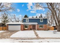 Attractive two-story home with brick and blue siding, attached garage, and snowy front yard at 502 E Lake Ave, Centennial, CO 80121