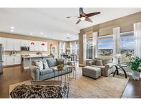 Bright, open-concept living room flows into modern kitchen and dining area with lots of natural light at 7408 Xenophon St, Arvada, CO 80005