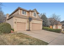 Charming two-story home featuring a spacious three-car garage and basketball hoop on an expansive concrete driveway at 5470 S Jasper Way, Centennial, CO 80015