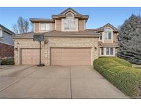 Inviting two-story home featuring a brick facade and a spacious two-car garage at 5470 S Jasper Way, Centennial, CO 80015
