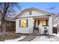 Charming white brick home featuring blue shutters and well-maintained front yard at 1901 S Lincoln St, Denver, CO 80210