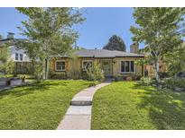 Charming single-story home with a well-manicured lawn and inviting walkway at 2844 Bellaire St, Denver, CO 80207