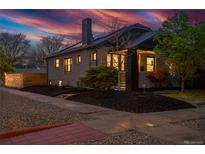 Charming brick home with a well-maintained yard and mature trees, perfect for enjoying the outdoors at 3105 N Elizabeth St, Denver, CO 80205