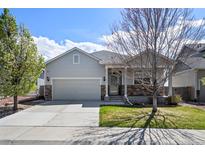 Charming single Gathering home with a two car garage, landscaped yard, and covered front porch at 401 Clubhouse Dr, Fort Lupton, CO 80621