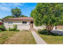 Charming single-story home featuring a well-maintained lawn and mature landscaping at 3055 S Winona Ct, Denver, CO 80236