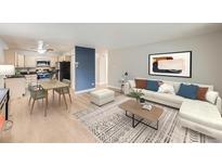 Bright living room featuring wood floors, neutral paint, an area rug, dining table, and modern furniture at 675 S Alton Way # 7A, Denver, CO 80247