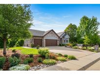 Beautiful home with a three-car garage, gorgeous landscaping, mature trees and a perfectly manicured lawn at 4532 Christensen Cir, Littleton, CO 80123
