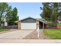 Charming single-story home with a brick exterior, a two-car garage, and a well-manicured front yard at 2495 S Lansing Way, Aurora, CO 80014