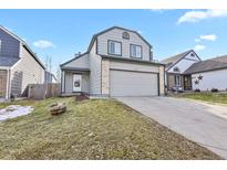 Two-story house with gray siding, attached garage, and small front yard at 5428 W 115Th Dr, Westminster, CO 80020