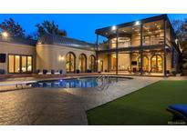 An in-ground pool sits on a stamped concrete patio with plenty of space for entertaining in this luxurious home at 9 Sedgwick Dr, Englewood, CO 80113