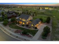 Beautiful aerial view of a two-story home with a landscaped yard and a three car garage at dusk at 5605 Killen Ave, Castle Rock, CO 80104