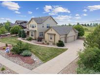 Beautiful two-story home with a three-car garage and lush landscaped front yard at 5605 Killen Ave, Castle Rock, CO 80104