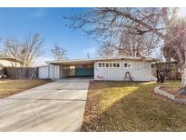 Charming single story home with an attached carport and mature landscaping at 2600 Valley View Dr, Denver, CO 80221