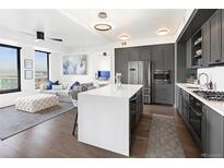 Modern kitchen with stainless steel appliances and an island at 1750 Wewatta St # 1521, Denver, CO 80202