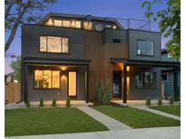 Modern two-story home boasting a rooftop deck and sleek contemporary design with a manicured lawn at 2450 S Cherokee St, Denver, CO 80223
