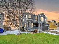 Charming two-story home featuring a covered porch, well-maintained lawn, and attached two-car garage at 5249 Mt Arapaho Cir, Frederick, CO 80504