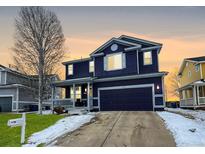 Charming two-story home with an attached two-car garage and inviting covered front porch at 5249 Mt Arapaho Cir, Frederick, CO 80504