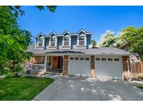Inviting two-story home with a well-maintained front yard and an attached two-car garage at 7773 Gunsight Pass, Littleton, CO 80127