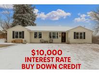 Charming ranch-style home with a well-maintained front yard and snow covered lawn at 3865 Independence Ct, Wheat Ridge, CO 80033