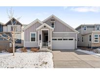 Charming craftsman style home with gray siding and a two-car garage at 838 N Yantley St, Aurora, CO 80018