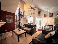 Inviting living room featuring a spiral staircase and vaulted ceilings at 4933 S Carson St # 212, Aurora, CO 80015