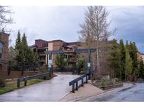 Powderhorn residence featuring brick accents, trees, and an inviting entrance at 765 Columbine St # C203, Breckenridge, CO 80424