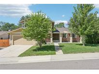 Charming two-story brick home with mature trees and a well-manicured lawn at 6559 S Locust Way, Centennial, CO 80111