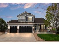 Charming two-story home with a three-car garage and well-manicured lawn at 688 Cinnabar Ln, Castle Rock, CO 80108