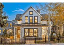 Charming two-story home featuring a black metal fence, a covered porch, and a well-maintained yard at 224 S Ridge St, Breckenridge, CO 80424