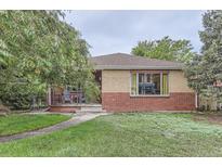 Charming brick home with a well-maintained lawn and a covered porch, exuding curb appeal at 1635 Winona Ct, Denver, CO 80204